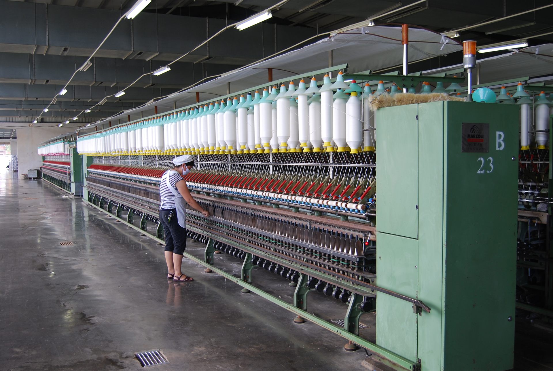 Operator walking the ring spinning line